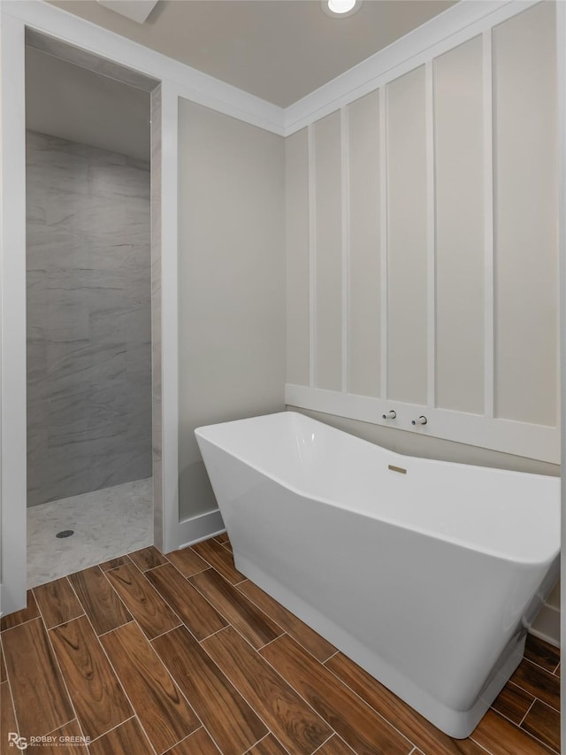 bathroom with ornamental molding and separate shower and tub