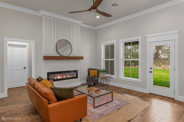 living room featuring crown molding, ceiling fan, and hardwood / wood-style floors