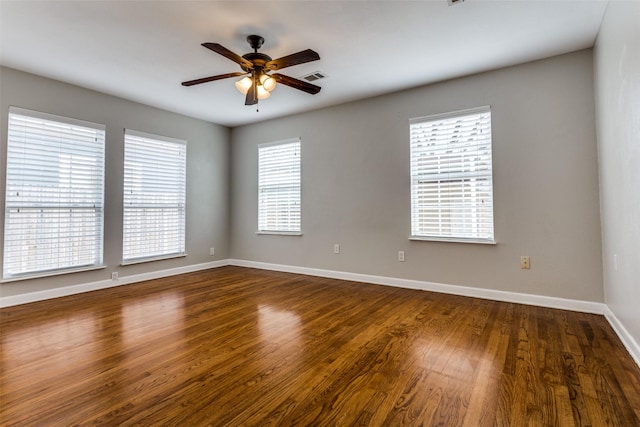 unfurnished room with ceiling fan and dark hardwood / wood-style flooring