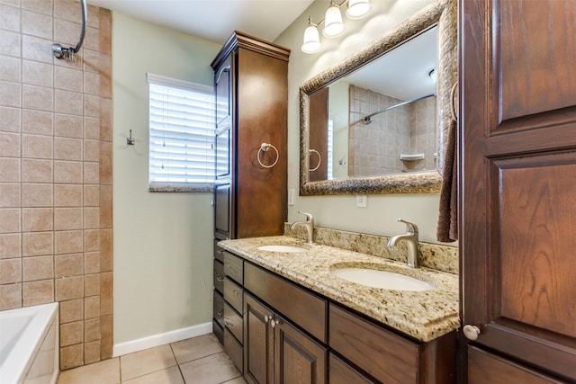 bathroom with vanity, tiled shower / bath combo, and tile patterned flooring