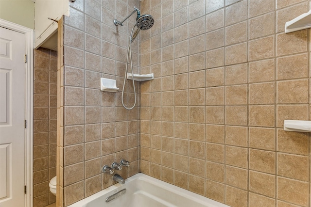 bathroom with tiled shower / bath combo and toilet