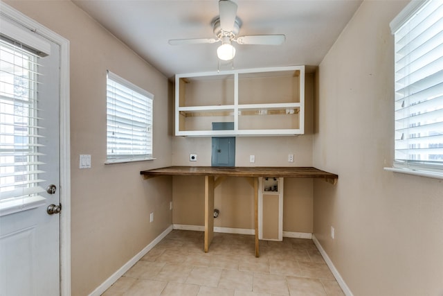 clothes washing area with ceiling fan, light tile patterned floors, hookup for an electric dryer, and a healthy amount of sunlight