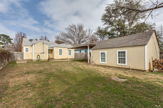 back of house with a lawn