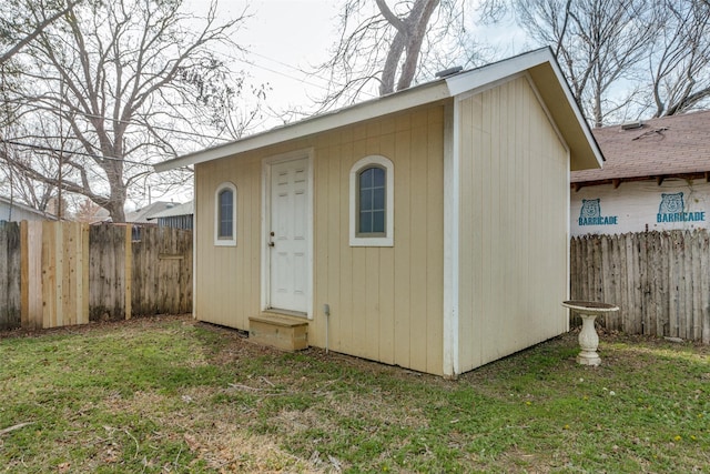 view of outbuilding with a yard