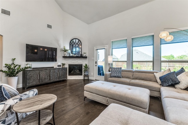 living room featuring dark hardwood / wood-style floors and high vaulted ceiling