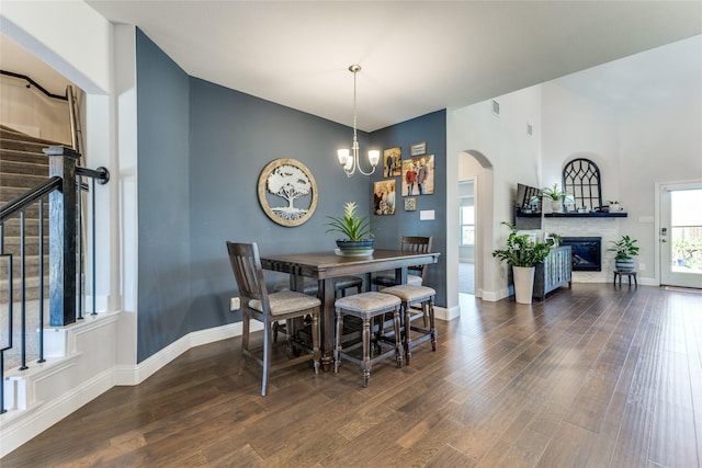 dining room with dark hardwood / wood-style floors and a chandelier