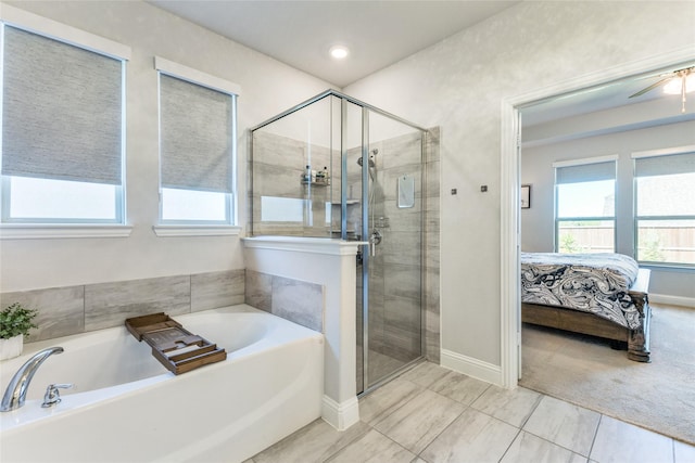 bathroom featuring shower with separate bathtub