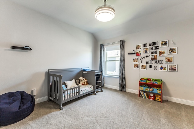 carpeted bedroom with vaulted ceiling and a crib