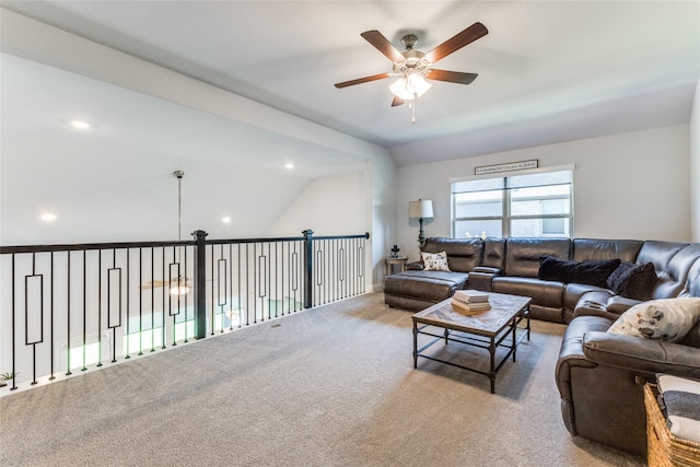 living room featuring ceiling fan, light colored carpet, and vaulted ceiling