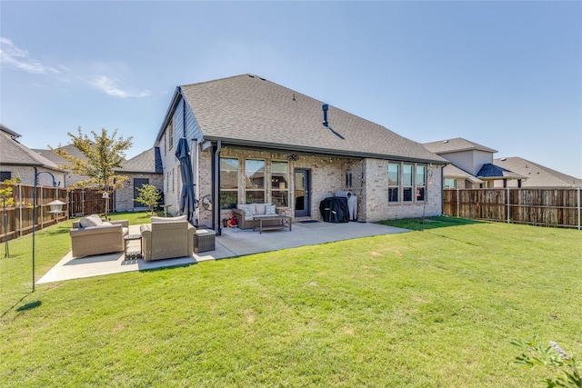 back of property featuring an outdoor living space, a patio, and a lawn