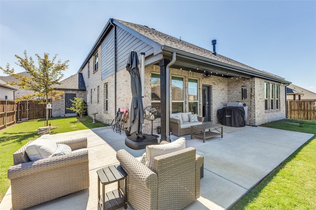 back of house featuring a patio, outdoor lounge area, and a lawn