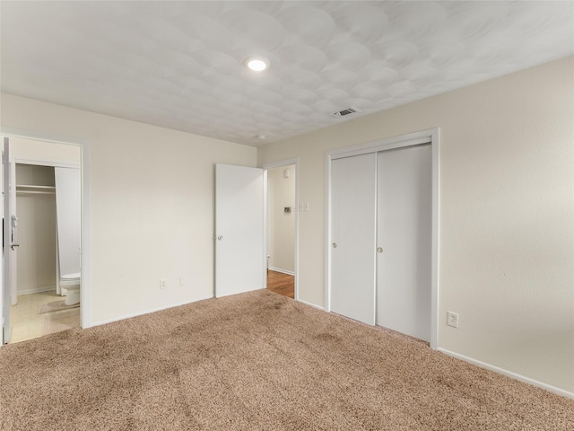 unfurnished bedroom with carpet and a closet