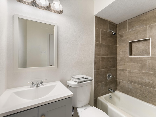 full bathroom with vanity, toilet, and tiled shower / bath combo