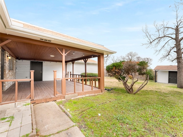 view of yard with a storage unit and a deck