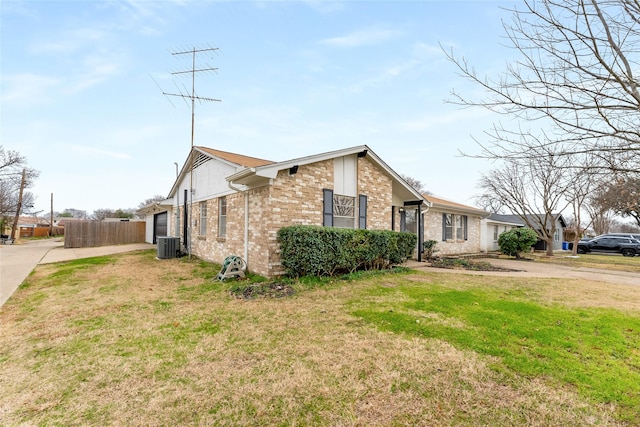 view of side of home with a yard and central air condition unit