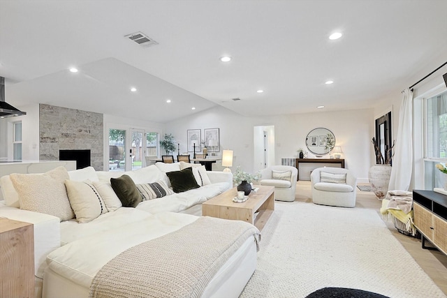 living room with lofted ceiling and light wood-type flooring