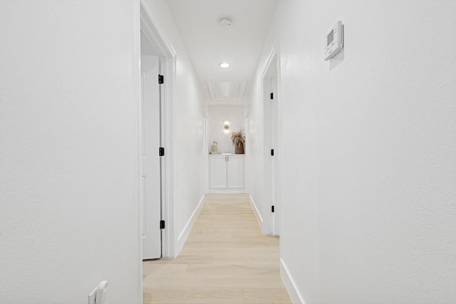 corridor with light hardwood / wood-style floors