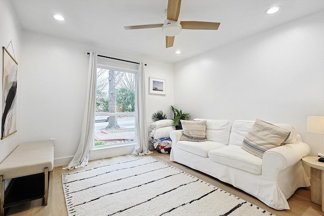 living room featuring ceiling fan and light hardwood / wood-style floors