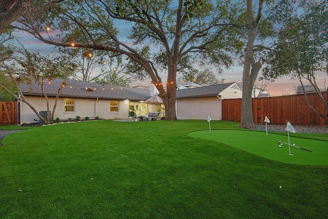 yard at dusk with a patio area