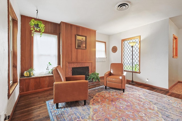 sitting room featuring a fireplace and dark hardwood / wood-style flooring