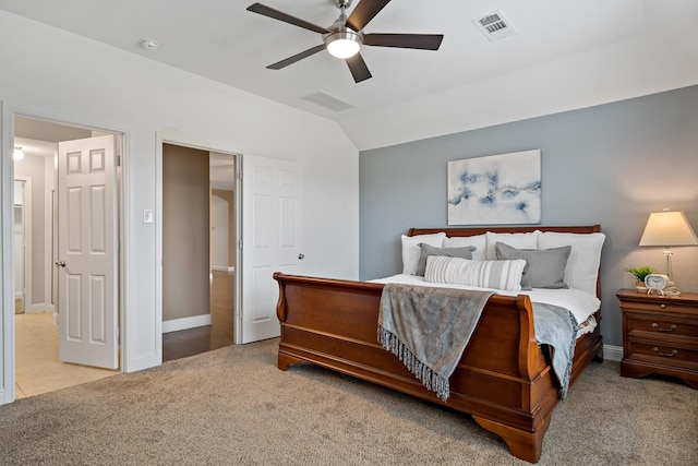 bedroom featuring carpet flooring, visible vents, baseboards, vaulted ceiling, and a ceiling fan