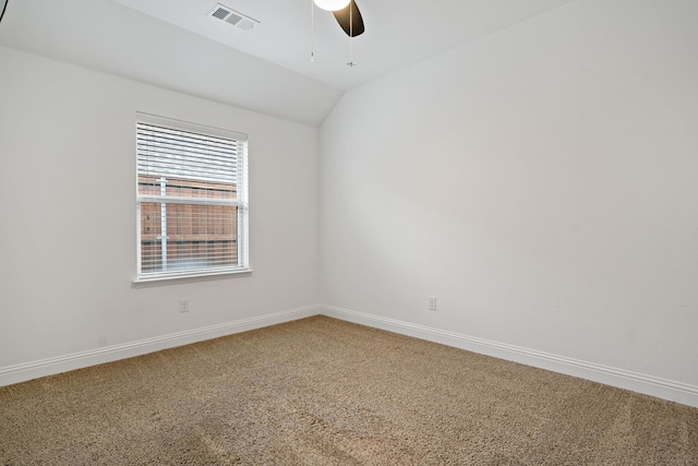 unfurnished room featuring lofted ceiling, a ceiling fan, visible vents, baseboards, and carpet