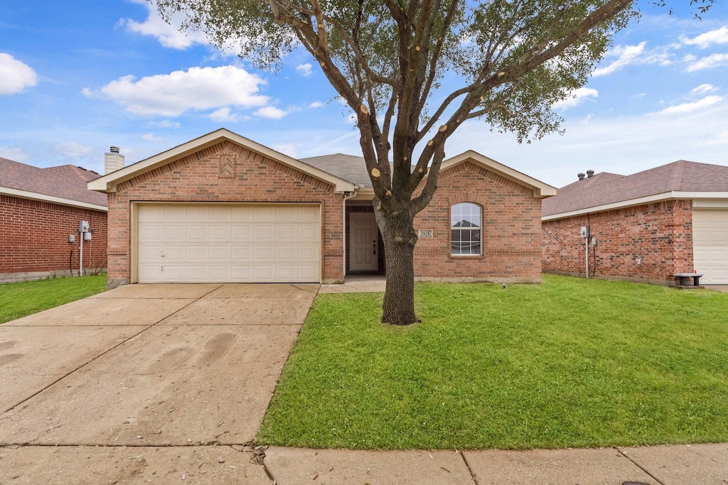 ranch-style house with a garage and a front lawn