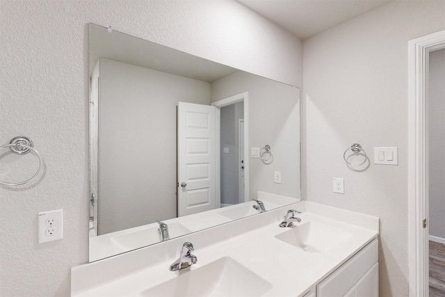 bathroom featuring vanity and hardwood / wood-style floors