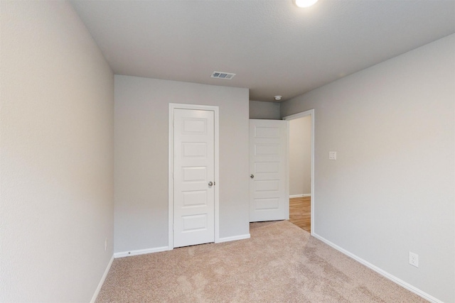 unfurnished bedroom with light carpet