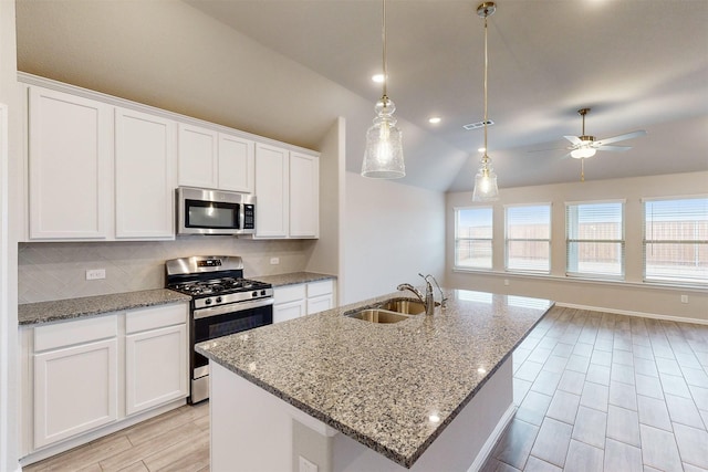 kitchen featuring white cabinetry, appliances with stainless steel finishes, and a center island with sink