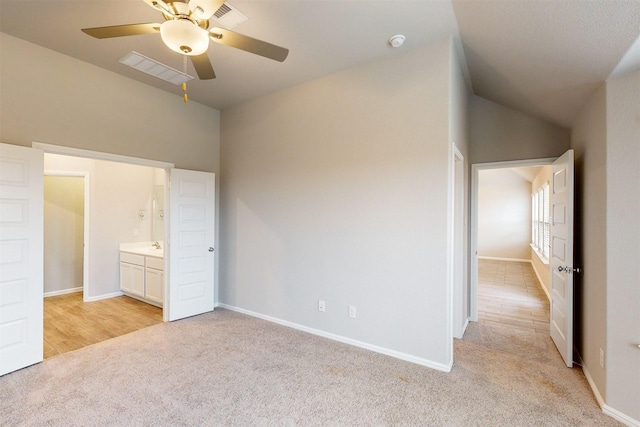 unfurnished bedroom with light carpet, lofted ceiling, and ceiling fan