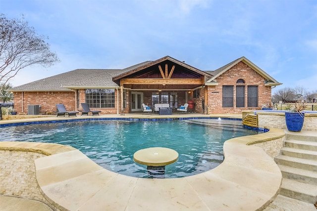 view of swimming pool featuring cooling unit and a patio area