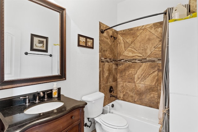 full bathroom featuring tiled shower / bath, vanity, and toilet