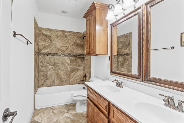 full bathroom featuring vanity, toilet, and tiled shower / bath