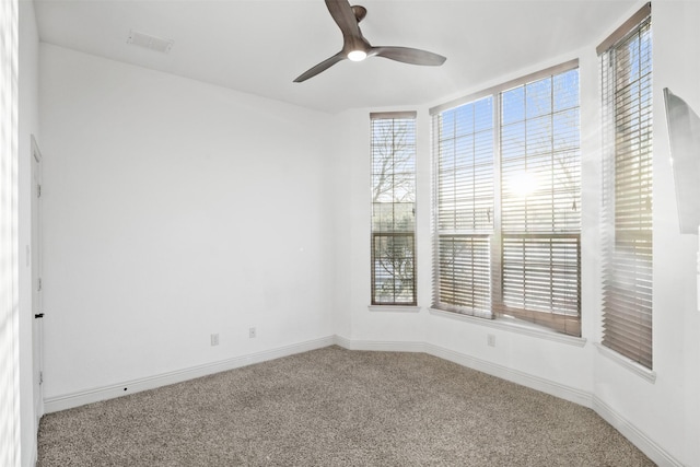 carpeted empty room featuring ceiling fan