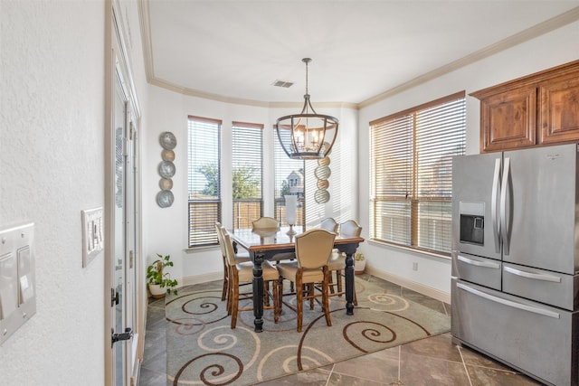 dining space with crown molding and an inviting chandelier