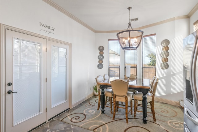 dining room featuring crown molding and a chandelier