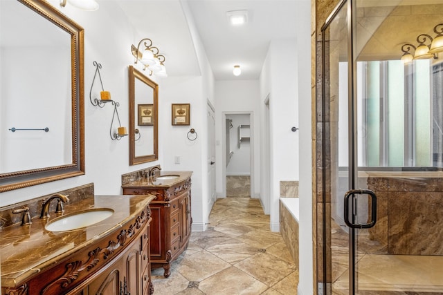 bathroom featuring vanity and separate shower and tub