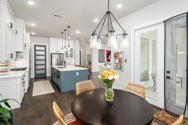 dining area featuring dark wood-type flooring and sink