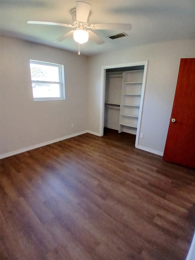 unfurnished bedroom with dark hardwood / wood-style floors and ceiling fan