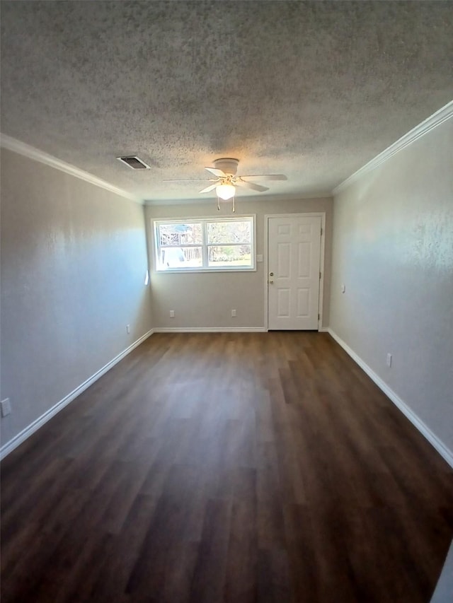 unfurnished room featuring crown molding, ceiling fan, dark hardwood / wood-style floors, and a textured ceiling