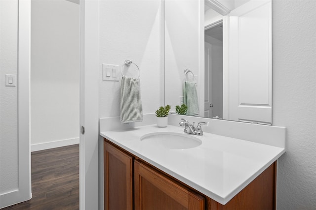 bathroom featuring hardwood / wood-style flooring and vanity