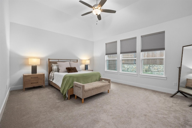 carpeted bedroom with vaulted ceiling and ceiling fan