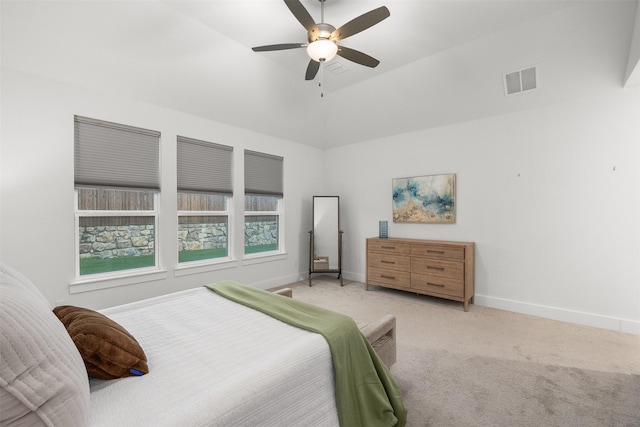 carpeted bedroom featuring ceiling fan and multiple windows