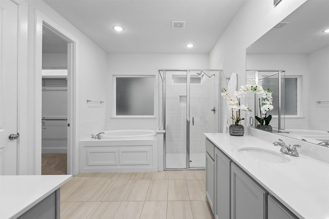 bathroom featuring vanity and separate shower and tub