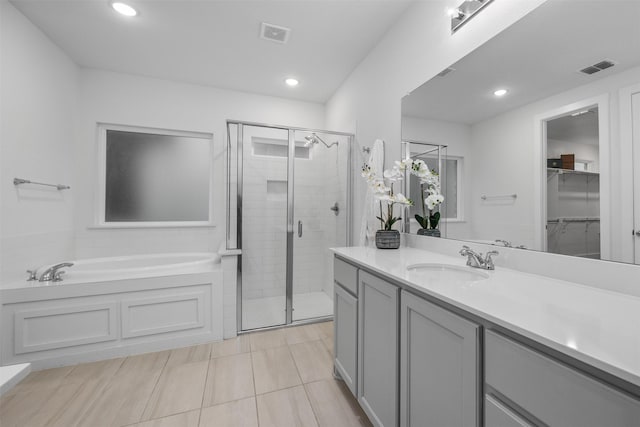 bathroom with vanity, separate shower and tub, and tile patterned flooring