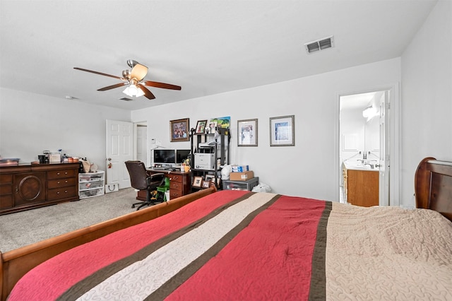 carpeted bedroom with ceiling fan and connected bathroom