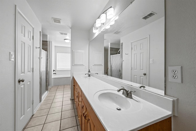 bathroom featuring tile patterned floors, independent shower and bath, and vanity