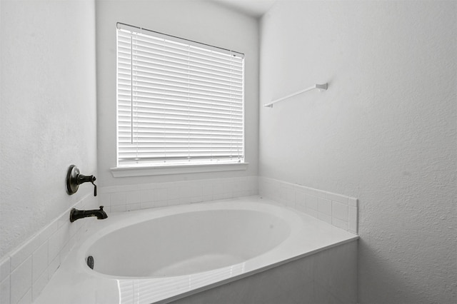 bathroom with a relaxing tiled tub