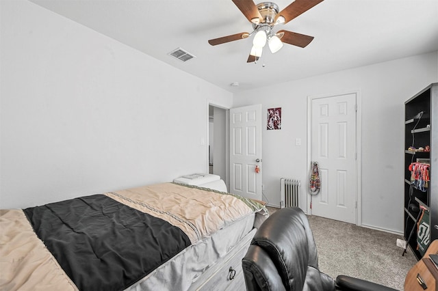 bedroom featuring ceiling fan, radiator, and carpet floors